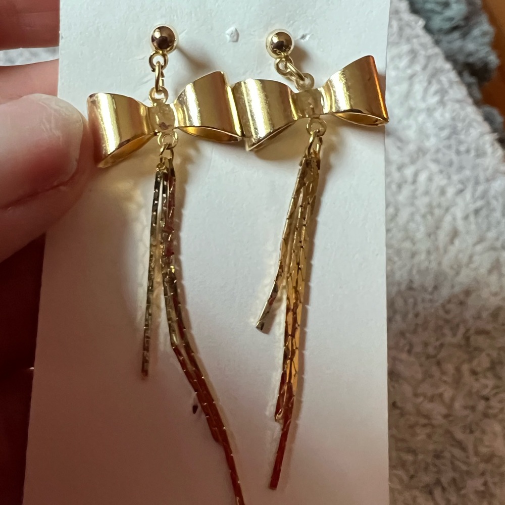 Bow mid century dangle earrings. Serpent chains with bows pierced.